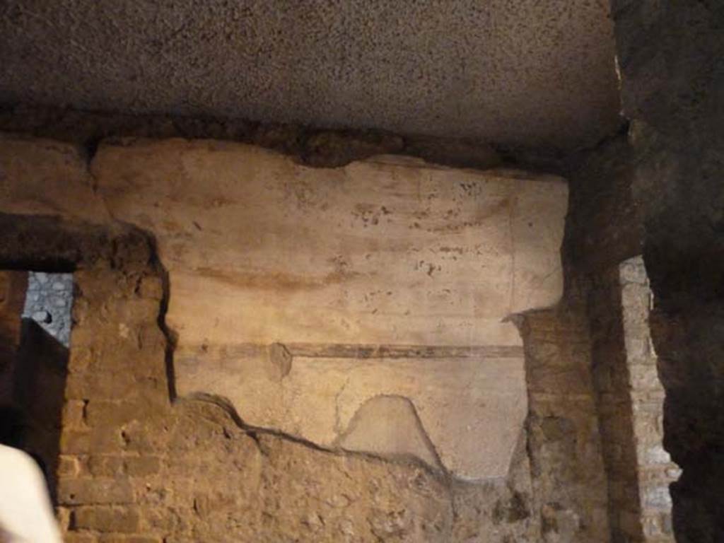 Oplontis, September 2015. Room 9, remains of painted decoration at east end of north wall. Doorway to room 7, on left,  and entrance doorway into room 4, on right.
