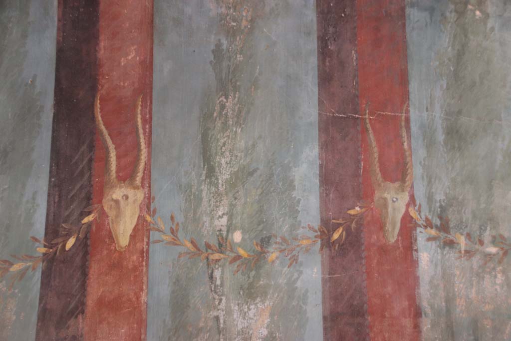 Oplontis Villa of Poppea, September 2021. 
Room 15, detail of painted Bukrania at north end of east wall. Photo courtesy of Klaus Heese.