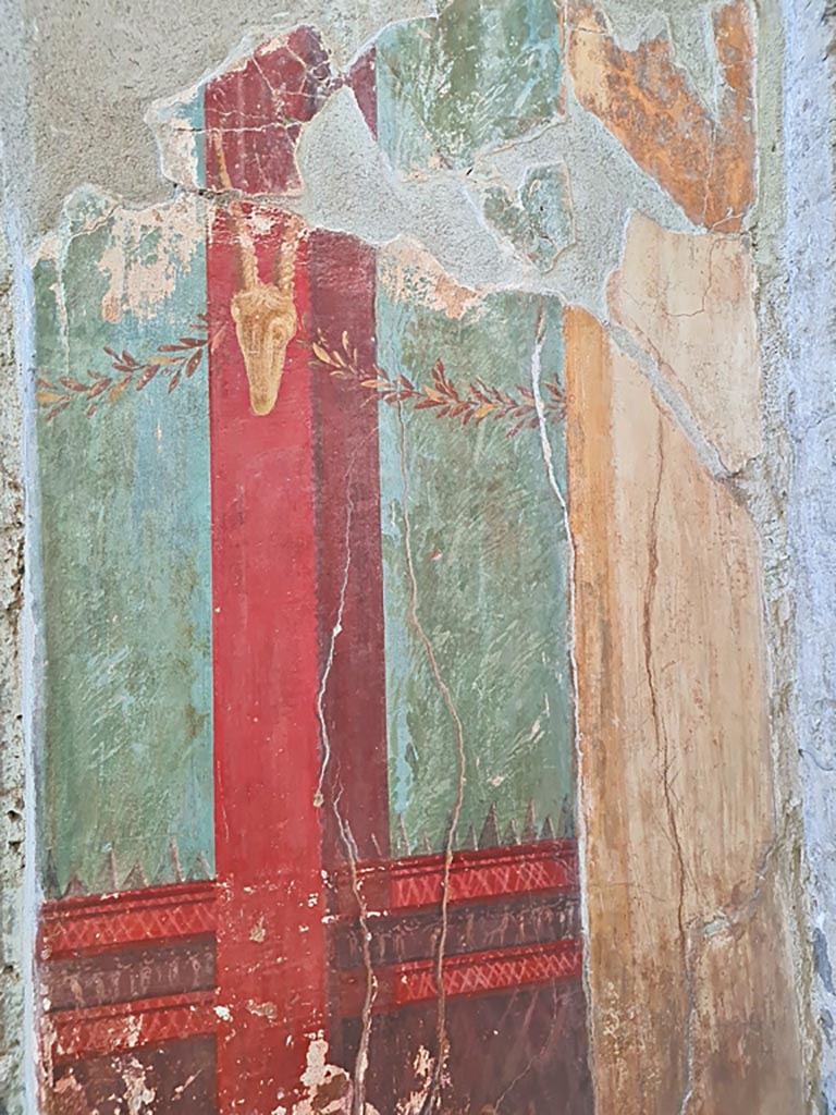 Oplontis Villa of Poppea, October 2023. 
Room 15, detail of painted decoration at side of doorway to room 14, in east wall in south-east corner. 
Photo courtesy of Giuseppe Ciaramella.
