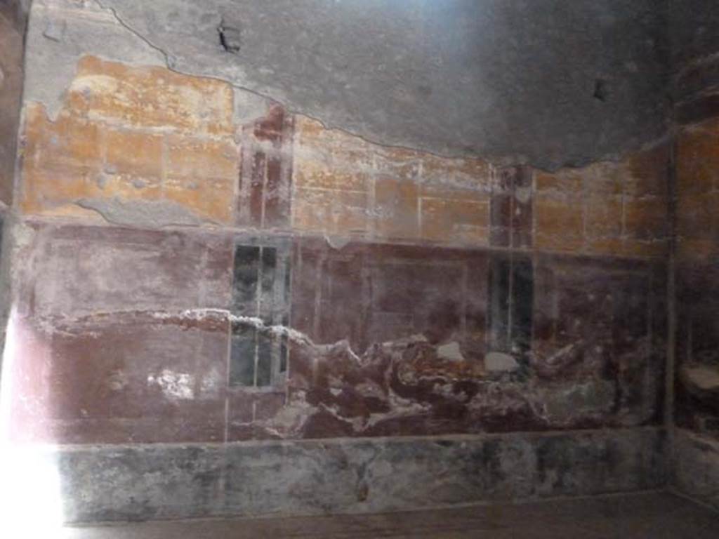 Oplontis, September 2015. Room 18, north wall. The walls had a black background at the bottom (the zoccolo), with red in the middle forming large panels with vignettes of painted birds pecking at fruit.