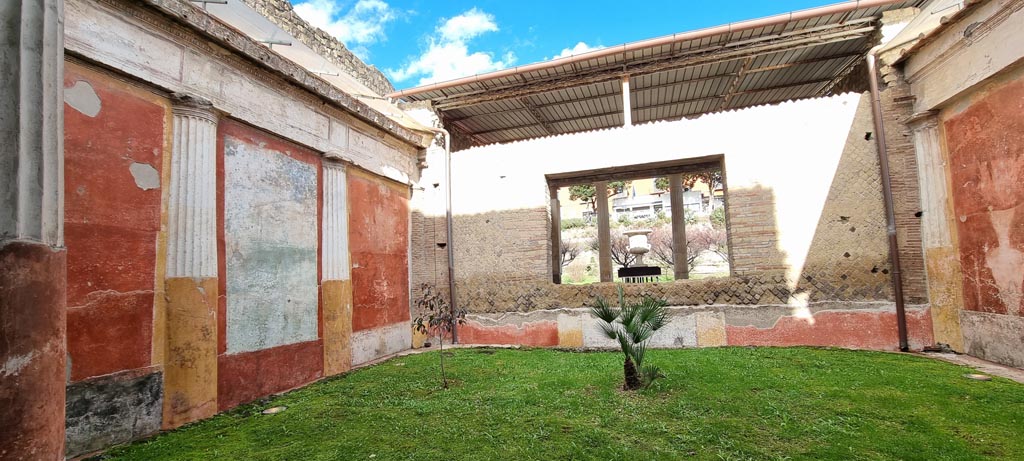 Oplontis Villa of Poppea, January 2023. 
Room 20, looking north across courtyard garden with large window into large room 21. Photo courtesy of Miriam Colomer.