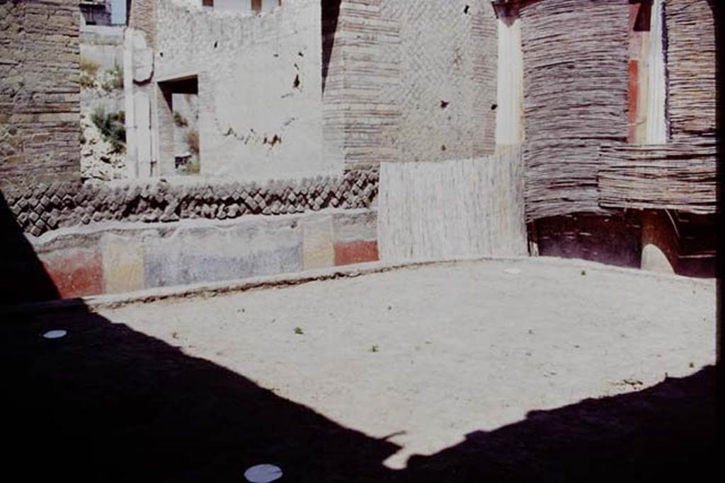 Oplontis, 1975. Area 20, the enclosed garden, looking towards the north-east corner. 
The white painted circles are the locations of the root cavities. According to Wilhelmina, “In the north-west, north-east and south-west corners a root cavity was found. There was not one found in the south-east corner as this would have blocked the entrance to the garden.” Photo by Stanley A. Jashemski.   
Source: The Wilhelmina and Stanley A. Jashemski archive in the University of Maryland Library, Special Collections (See collection page) and made available under the Creative Commons Attribution-Non Commercial License v.4. See Licence and use details. J75f0524