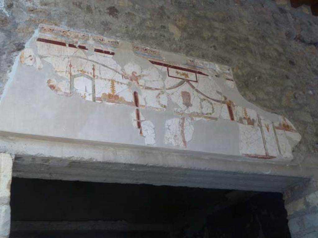 Oplontis, May 2011. Room 23, detail of painted decoration above doorway in portico 24.  Photo courtesy of Michael Binns.