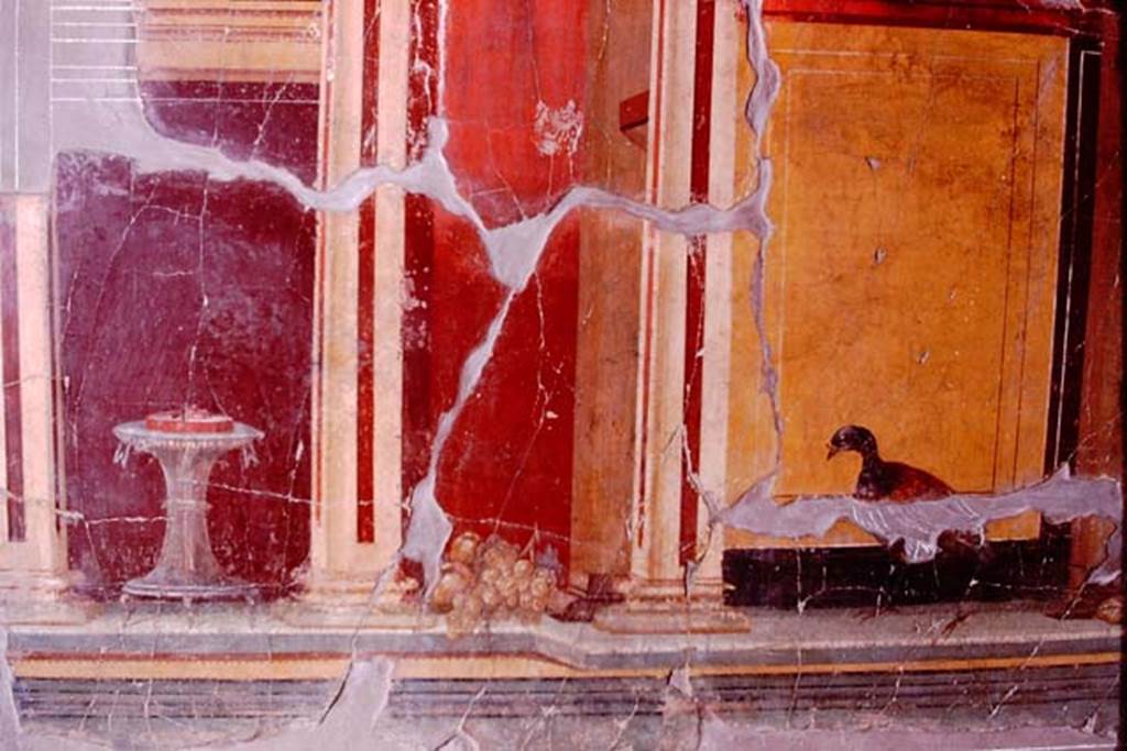 Oplontis, 1974. Room 23, detail from side wall showing a painted table with a column-like foot, a bunch of grapes and a bird. Photo by Stanley A. Jashemski.   
Source: The Wilhelmina and Stanley A. Jashemski archive in the University of Maryland Library, Special Collections (See collection page) and made available under the Creative Commons Attribution-Non Commercial License v.4. See Licence and use details. J74f0655