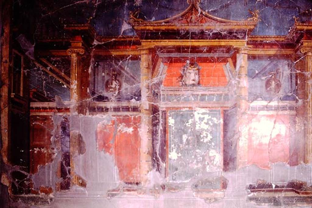 Oplontis, 1974. Room 23, west wall with painted tragic mask, in the centre. Photo by Stanley A. Jashemski.   
Source: The Wilhelmina and Stanley A. Jashemski archive in the University of Maryland Library, Special Collections (See collection page) and made available under the Creative Commons Attribution-Non  Commercial License v.4. See Licence and use details. J74f0652