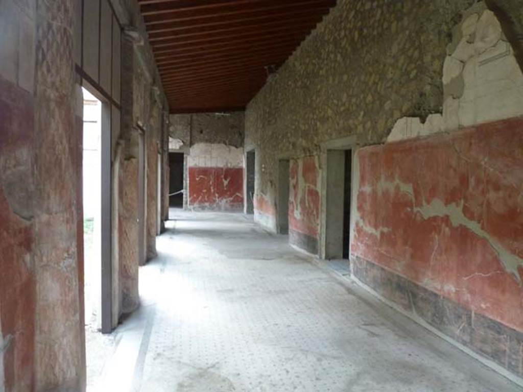 Oplontis Villa of Poppea, September 2015. Portico 24, looking west from east end.
Malandrino describes - “the southern portico with columns painted on the inside and fluted in stucco on the outside. 
The spaces between the columns were partially closed by masonry panels to protect both the porticoes themselves as well as the rooms that face onto them, from the summer heat and from the rain and the southerly winds.”
See Malandrino, C. (1978). Oplontis Villa of Poppea, (p. 72), where Room 24, is described as Room 19 on the plan).