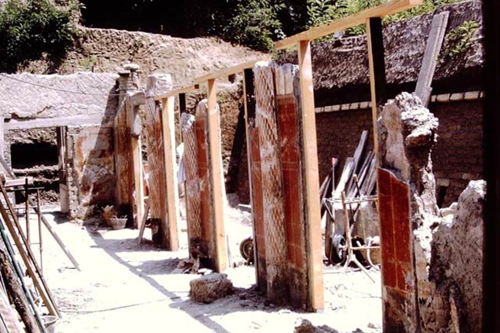 Oplontis, 1973. Looking east along portico 24 in the south-eastern part of the Villa. 
The south-west part of Peristyle 59, with the wheel-barrows, can be seen through the “doorways” between the columns. Photo by Stanley A. Jashemski. 
Source: The Wilhelmina and Stanley A. Jashemski archive in the University of Maryland Library, Special Collections (See collection page) and made available under the Creative Commons Attribution-Non Commercial License v.4. See Licence and use details. J73f0366