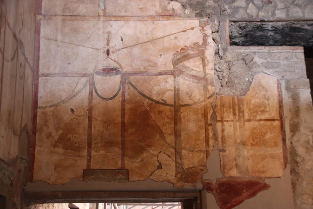 Oplontis Villa of Poppea, October 2022. 
Room 27, detail of painted west wall above doorway to room 1. Photo courtesy of Klaus Heese.