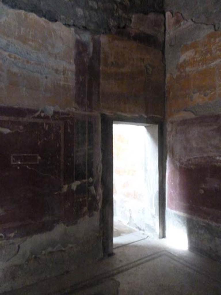 Oplontis, September 2015. Room 31, doorway in west wall of tepidarium, room 18, leading to possible room used as frigidarium. 
Secondo a Carlo Malandrino - Ambiente destinato probabilmente a frigidarium del complesso termale. Non interamente portato alla luce, perche coperto, per oltre la meta, dal terrapieno stradale. Vedi Malandrino, Carlo, 1978. “Oplontis”, (p.72, ambiente 18 sulla pianta).
(translation: Room probably used as frigidarium of the baths complex. Not entirely brought to light, because it is covered for over half of it, by the road embankment.)
See Malandrino, Carlo, 1978. “Oplontis”, (p.72, room 18 on plan).