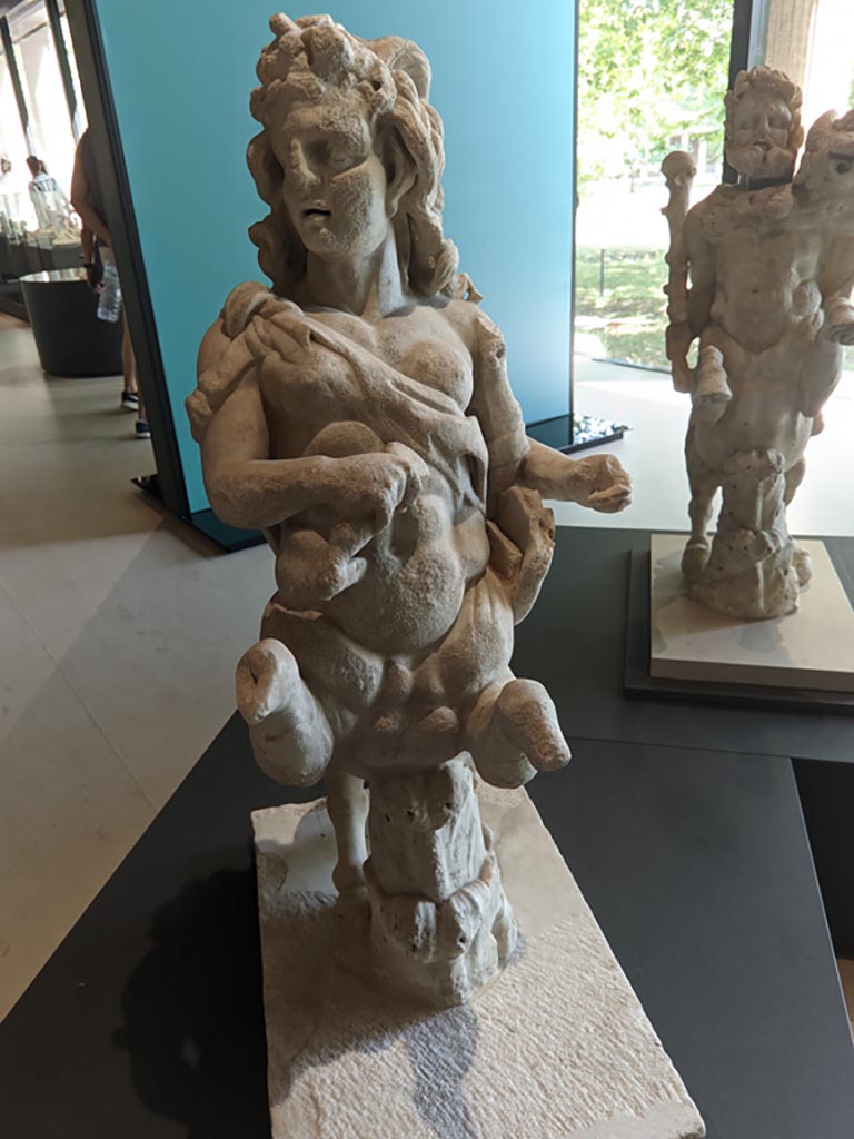 Oplontis Villa of Poppea, April 2022. 
Statuette of a female holding a club and a lyre. Photo courtesy of Giuseppe Ciaramella.