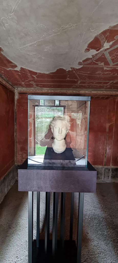 Oplontis Villa of Poppea, January 2023. On display in room 38. 
Head of Aphrodite, 1st century AD. 
Found in the north garden on 12th June 1974. 
The head lay on the ancient soil layer about 7m north of the last, northernmost column of Portico 34. 
According to the villa information board, the head depicts the features of the goddess in a replica of the Capitoline Venus type, inspired by the works of Praxiteles from the 4th century BC. 
The elaborate hairstyle, held in place by a band, ends in a voluminous knot on the top of the head.
Inventory number 71321.
Photo courtesy of Miriam Colomer.