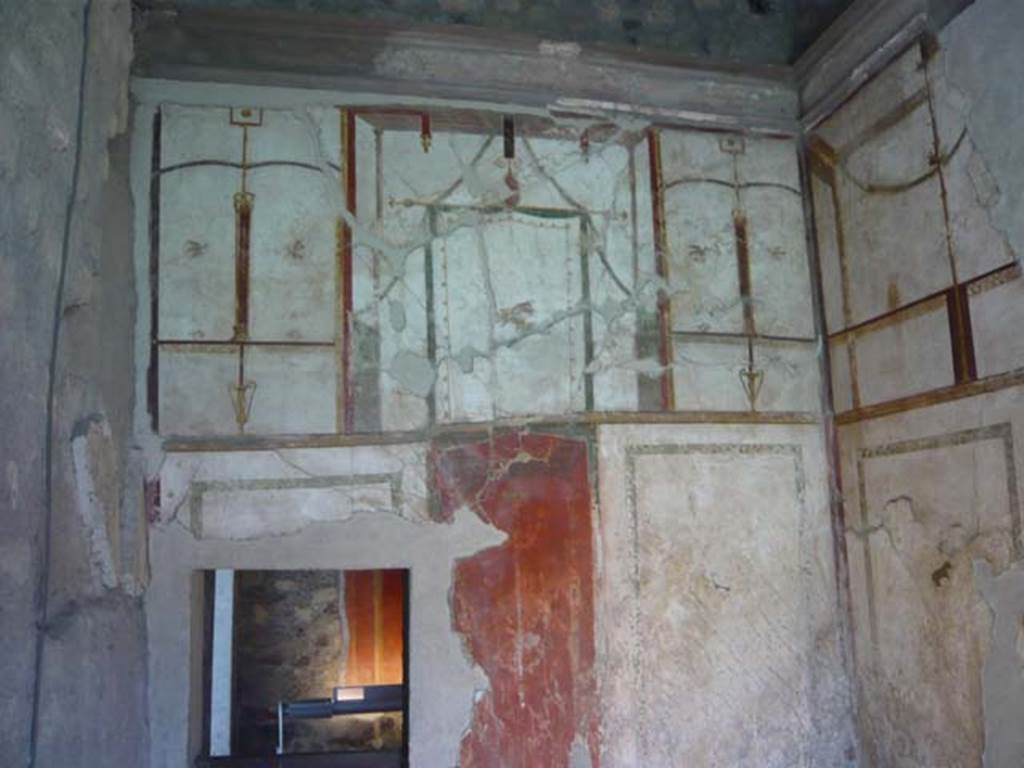 Oplontis, May 2010. Room 41, painted decoration on upper west wall of alcove. 
The small doorway leads into room 38. Photo courtesy of Buzz Ferebee.
