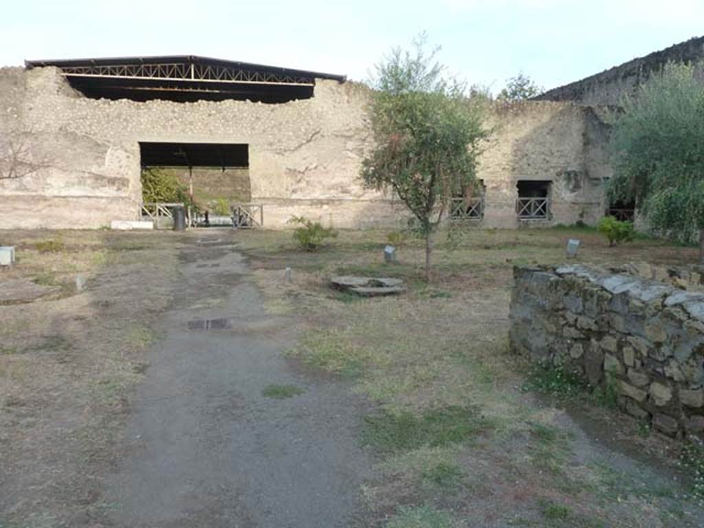Oplontis Villa of Poppea, September 2015. Looking east towards east side of north garden 56, along the pathway to Exedra 69.
Another Wilhelmina Jashemski plaster-cast can be seen on the centre-right. 
The wall on the right is part of room 58, in which she also found root-cavities.