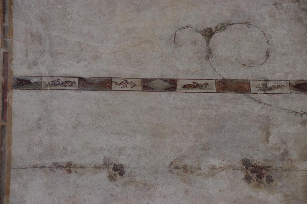 Villa of Poppaea, Oplontis, October 2023. 
Area 60, detail of painted decoration from upper west portico wall on north (right) of doorway to room 72. Photo courtesy of Klaus Heese.
