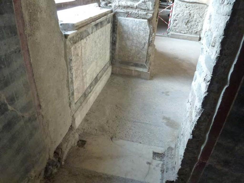 Oplontis, September 2011. Room 64, looking north through doorway from corridor 63, towards the wall zoccolo and base of the niche/recess in room 64. Photo courtesy of Michael Binns.