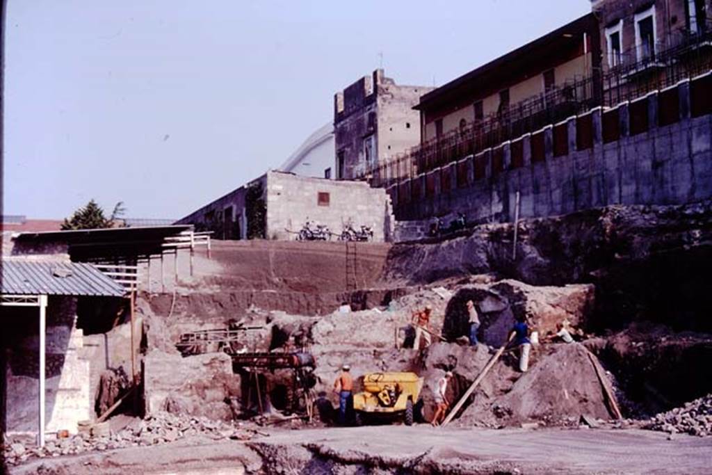 Oplontis Villa of Poppea, c.1984. 
Looking north-west towards excavations in the north-west corner of the pool area.
On the left is the plaster between room 74 and doorway to room 88 on the north side of area 60.
On the right, the plaster above the doorway to room 97 can be seen emerging from the lapilli.
Source: The Wilhelmina and Stanley A. Jashemski archive in the University of Maryland Library, Special Collections (See collection page) and made available under the Creative Commons Attribution-Non Commercial License v.4. See Licence and use details.
Oplo0220