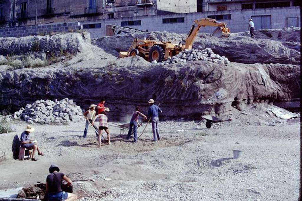 Oplontis, 1975. Wilhelmina documenting, sitting on the left, while the north garden is being dug-out both mechanically and by hand. Photo by Stanley A. Jashemski.   
Source: The Wilhelmina and Stanley A. Jashemski archive in the University of Maryland Library, Special Collections (See collection page) and made available under the Creative Commons Attribution-Non Commercial License v.4. See Licence and use details. J75f0013