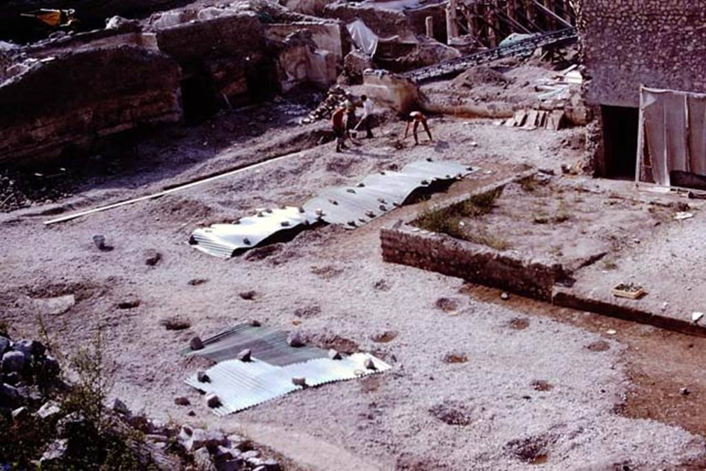 Oplontis, 1975. Looking south-east across north garden and sites of cavities, towards room 64 with two doorways. Photo by Stanley A. Jashemski.   
Source: The Wilhelmina and Stanley A. Jashemski archive in the University of Maryland Library, Special Collections (See collection page) and made available under the Creative Commons Attribution-Non Commercial License v.4. See Licence and use details. J75f0109