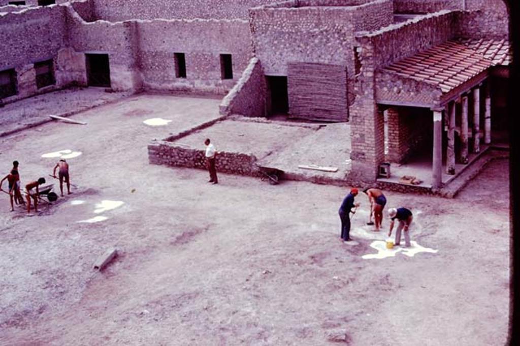 Oplontis, 1977. Cleaning and tidying the north garden, ready for the “balloon” photos. The root cavities are being painted white, to ensure they show up from the air. Photo by Stanley A. Jashemski.   
Source: The Wilhelmina and Stanley A. Jashemski archive in the University of Maryland Library, Special Collections (See collection page) and made available under the Creative Commons Attribution-Non Commercial License v.4. See Licence and use details. J77f0248
