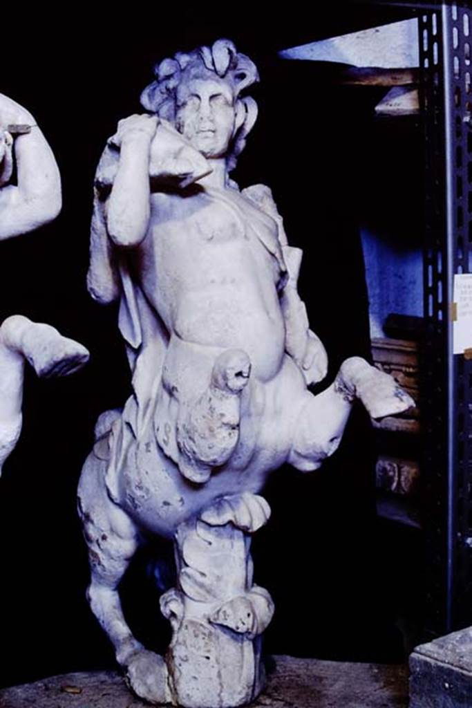Oplontis Villa of Poppea, 1977. One of a group of four centaurs, a female holding a club and a fawn on her shoulder. 
Two centaur fountains had been on each side of the passageway.
There was no evidence of pipes, so they had not been used as fountains in their final location.
Photo by Stanley A. Jashemski.
SAP{ inventory number 70071.
Source: The Wilhelmina and Stanley A. Jashemski archive in the University of Maryland Library, Special Collections (See collection page) and made available under the Creative Commons Attribution-Non Commercial License v.4. See Licence and use details.
J77f0339
According to De Caro, a group of four centaurs were found under portico 33 on 17th February 1970. 
When they were found, they were very badly damaged. Heads and limbs were mostly detached and it was necessary to provide patient and pain-staking work of re-composition. 
See De Caro, S.1976. Sculture dalla villa “di Poppea” in Oplontis (p.198) in Cronache Pompeiane, II, 1976, (p.184-225)