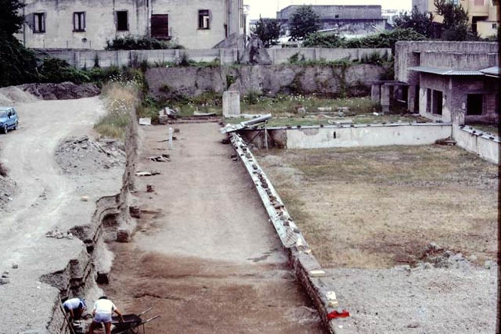 Oplontis Villa of Poppea, July 1983. Statue base 10 being dug out, and discovery alongside it in the lapilli. 
Source: The Wilhelmina and Stanley A. Jashemski archive in the University of Maryland Library, Special Collections (See collection page) and made available under the Creative Commons Attribution-Non Commercial License v.4. See Licence and use details. Oplo0185
According to Wilhelmina - “There was great excitement at Oplontis when a headless statue of Nike/Victory was found in front of base 10. (X).  As we excavated the soil behind the statue bases on the north where there had been a considerable covering of lapilli, we found the soil contours of plantings with root cavities which we emptied. In them we found considerable charcoal, which when analysed proved to be oleander.”
See Jashemski, W.F., 2014. Discovering the Gardens of Pompeii: Memoirs of a Garden Archaeologist, (p.289).