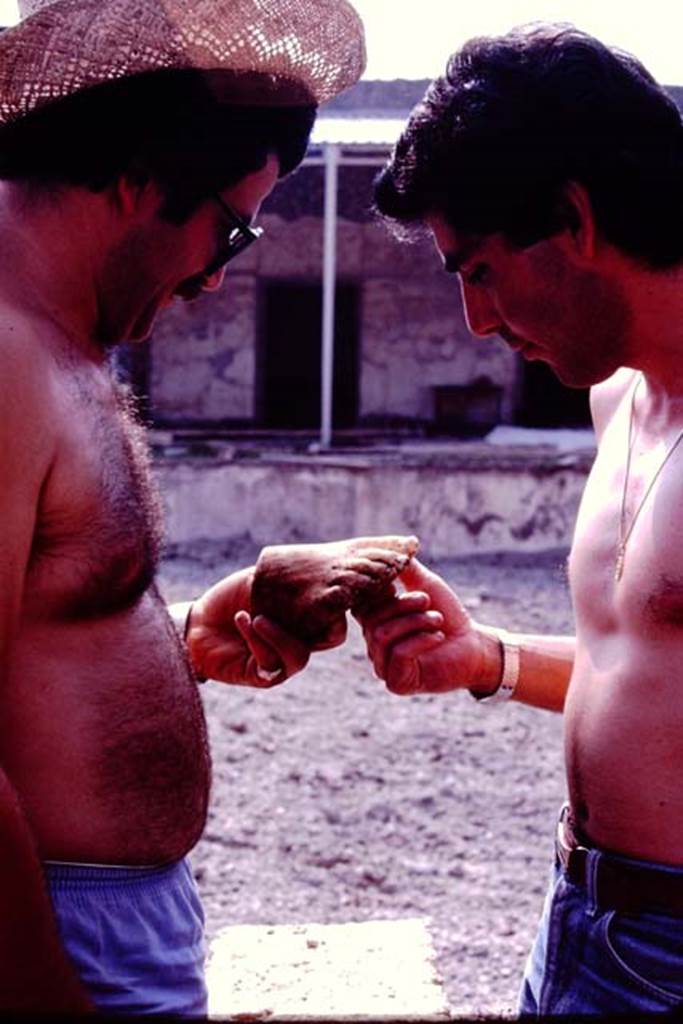 Oplontis Villa of Poppea, July 1983. Examining the broken foot from a statue.  
Source: The Wilhelmina and Stanley A. Jashemski archive in the University of Maryland Library, Special Collections (See collection page) and made available under the Creative Commons Attribution-Non Commercial License v.4. See Licence and use details. Oplo0223