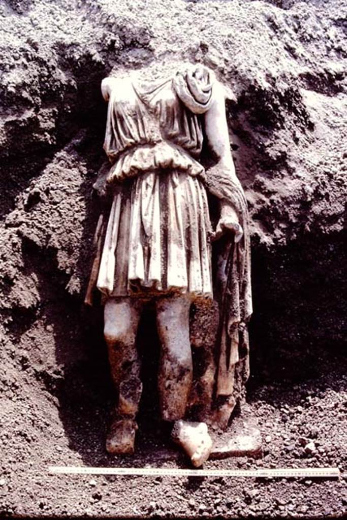 Oplontis Villa of Poppea, July 1983. Headless statue of Artemis/Diana found still standing on the statue base, and reunited with both feet. 
Source: The Wilhelmina and Stanley A. Jashemski archive in the University of Maryland Library, Special Collections (See collection page) and made available under the Creative Commons Attribution-Non Commercial License v.4. See Licence and use details.
Oplo0229