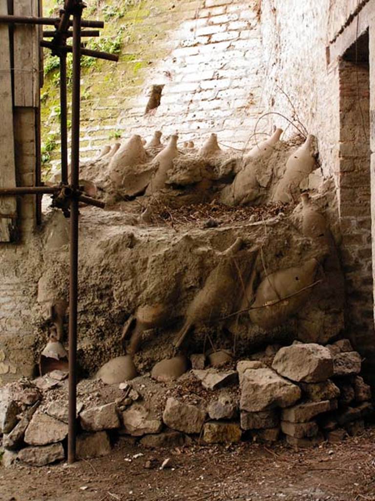 Oplontis, Villa of Lucius Crassius Tertius. March 2005. 
Room 18bis Amphorae stacked upside down outside the door of room 17. 
Photo courtesy of Massimo Gravili.
In their 2014 season the Oplontis Project undertook the cataloguing of stored materials that remained from previous excavations. 
They catalogued some 600 amphora, a significant increase from the 400 previously reported.
See http://www.fastionline.org/excavation/micro_view.php?fst_cd=AIAC_334&curcol=sea_cd-AIAC_5748