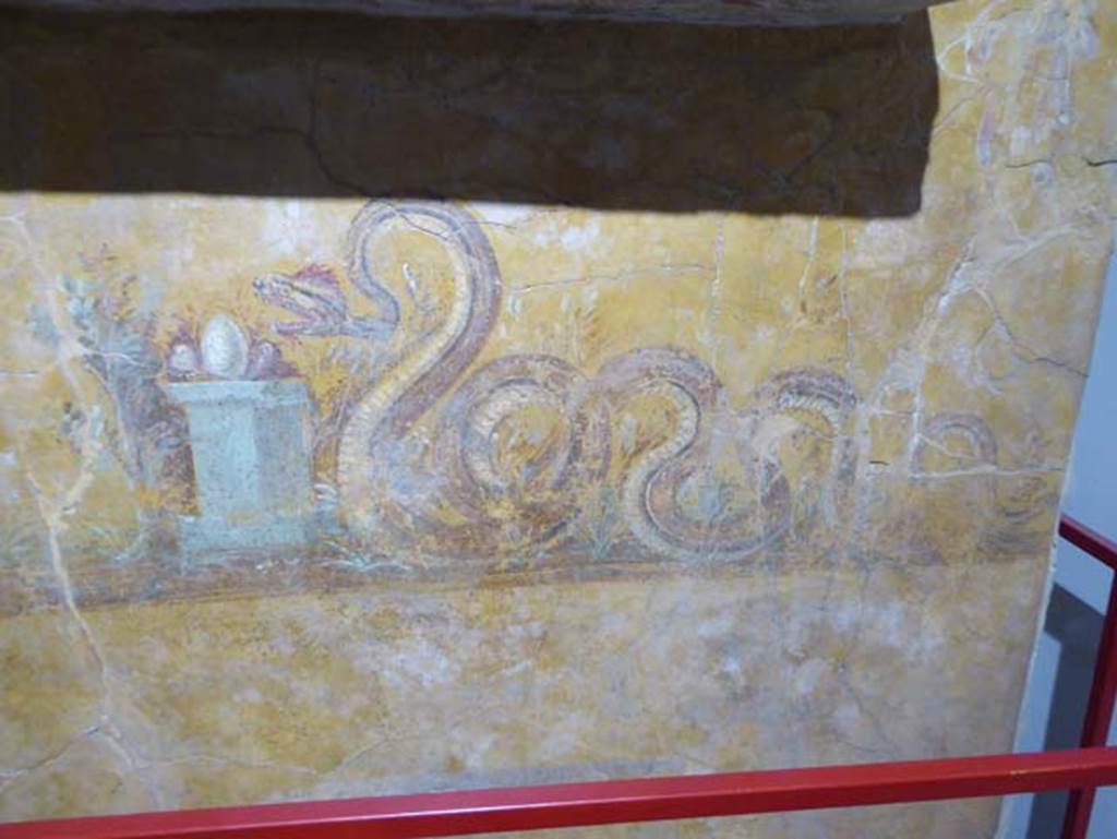 Gragnano, Villa rustica in Località Carmiano, Villa A. June 2017. Underneath the aedicula lararium, a painted serpent is moving towards an altar on which was an egg and other offerings. 
Photo courtesy of Michael Binns.