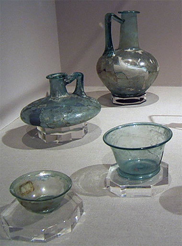 Gragnano, Villa rustica in Località Carmiano, Villa A. Glass items found in the villa.
Stabiae Antiquarium, inventory numbers 
63519 tall glass bottle with flared rim and handle, from room 9, reassembled form fragments.
63408 taller light green cup, from room 6, reassembled from fragments.
63395 lower light green cup with splayed rim, from room 6, found intact. 
61407 flat bottle is from Santa Maria La Carita, Villa Petraro.
See Bonifacio G., 2004. In Stabiano: Exploring the Ancient Seaside Villas of the Roman Elite. Castellamare: Nicola Longobardi, p. 133.