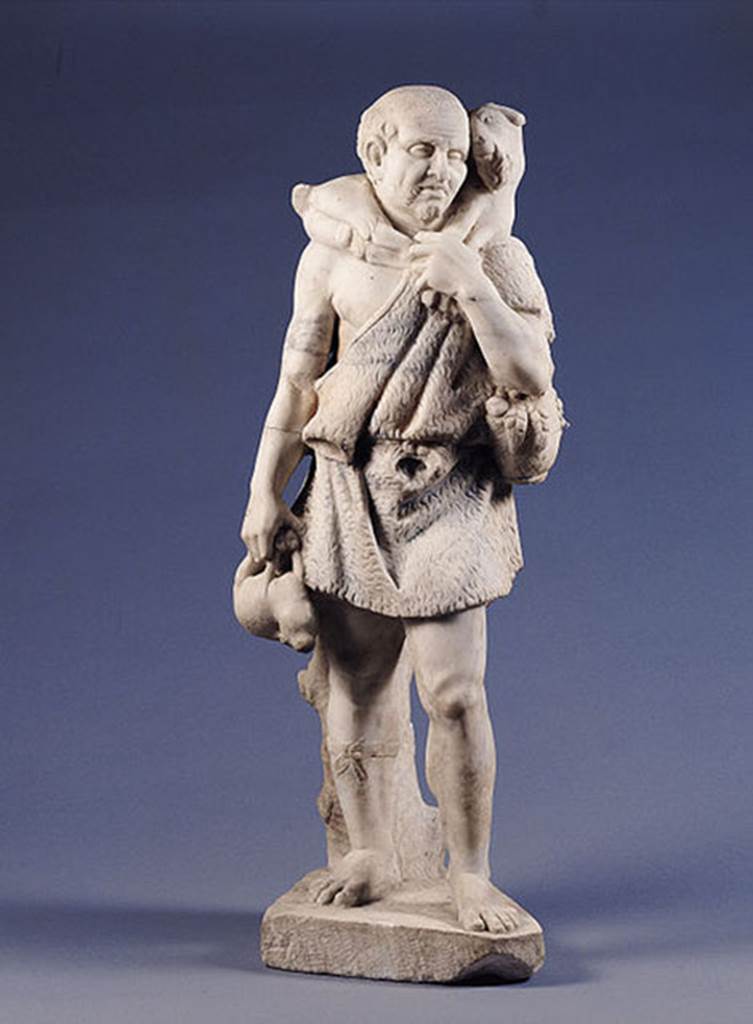 Castellamare di Stabia, Villa del Pastore. Statue of the shepherd. 
According to Kockel, he is dressed in a belted Fellexomis ( a form of Greek tunic). 
He carries a young goat on his shoulders, in his right hand he holds a hare. 
He holds a basket with fruit and carries a backpack with a loaf of bread sticking out. 
Garment, fruits and hair were coloured, but already are heavily faded.
See Kockel V., 1985. Funde und Forschungen in den Vesuvstadten 1: Archäologischer Anzeiger, Heft 3. 1985, p. 529ff, Abb. 11. 18. 23 Nr. 100.
Photo Wikimedia Commons, courtesy user Mentnafunangann..
This file is licensed under the Creative Commons Attribution-Share Alike 3.0 Unported.