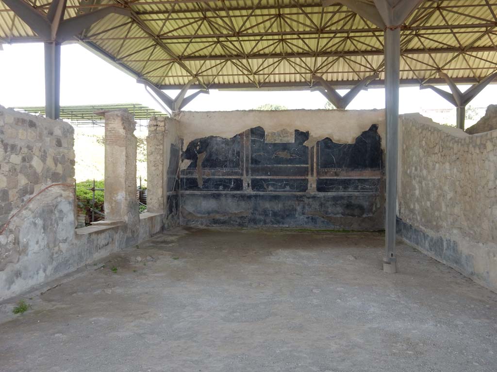 Stabiae, Secondo Complesso, June 2019. 
Room 13, looking south across flooring towards two windows in east wall overlooking peristyle. Photo courtesy of Buzz Ferebee.
The opus sectile flooring from this room had been completely detached in two stages, but it has been possible to reconstruct it due to the information furnished by Ruggiero.
During the first excavation by Weber, in 1762, a marble floor of various colours came to light, which was used to pave the first room of the Museo Reale at Portici.
In 1775, the room was re-excavated, and the remaining flooring was carried away together with the marble threshold. The flooring was used to pave the centre of a floor in the Real Museo Borbonico now the Naples Archaeological Museum.
See Ruggiero, M. Degli scavi di Stabia dal 1749 al 1782, (p.179).
According to Barker, Fant, Ward & Amiet –
“Room 13, with a floor area of 72 sq.m, it is amongst the largest of the eight rooms in Campania that feature wall-to-wall opus sectile paving. 
All of the marble has been stripped from the floor, but the pattern can be reconstructed from imprints in the mortar bedding and details provided by Ruggiero (Note 26, Ruggiero 1881: p.179). 
The pavement was excavated in 1762 by Weber and partly stripped to pave a room in the Museo Reale in Portici, now the Museo Ercolanese in the Reggia di Portici. (Note 27, see Allroggen-Bedel and Kammerer-Grothaus. 1980, p.200). 
Later in 1775 the room was re-excavated and the remaining marble from the pavement and the room’s marble threshold was stripped to pave one of the rooms in the Real Museo Borbonico. (Note 28 – The floor was located on the first floor of the Museo Nazionale di Napoli, but has subsequently been removed. (See PISAPIA, 1989: 55, Cat No. 104; 2002: 111-112.)
In Fig.14: a photograph of an opus sectile pavement can be seen, from room 13 in the Secondo Complex, relaid in room 142 at the Museo Ercolanese (after Pisapia 2002, 112 fig.5).
See Barker, et al: The Marmo al Mare Project 2013. Marble décor at the Roman Villas of Stabiae