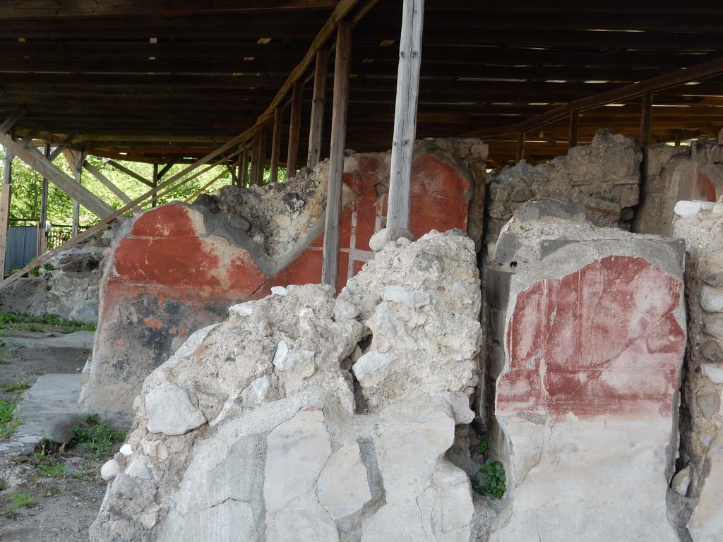 Stabiae, Secondo Complesso, June 2019. Room 11, red painted east wall at rear of room 12, east wall.
Photo courtesy of Buzz Ferebee.