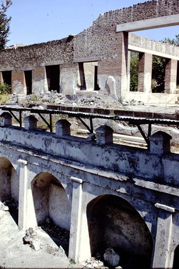 Villa Arianna, 1968. Doorway to the large windowed exedra room A, on right,  and rooms on its east side, above the arched wall on the terrace.  Photo by Stanley A. Jashemski
Source: The Wilhelmina and Stanley A. Jashemski archive in the University of Maryland Library, Special Collections (See collection page) and made available under the Creative Commons Attribution-Non Commercial License v.4. See Licence and use details. Jmis0092