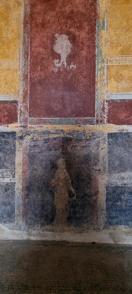 Stabiae, Villa Arianna, December 2023.
Room 11, figure on red panel below white panel on south wall, and figure on black painted zoccolo of lower south wall. 
Photo courtesy of Miriam Colomer.