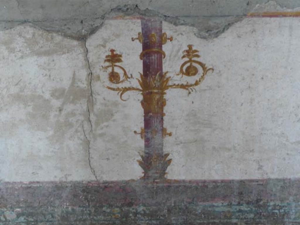 Stabiae, Villa Arianna, May 2010. Room 12, painted candelabra from south wall above painted figure in panel of zoccolo. Photo courtesy of Buzz Ferebee.