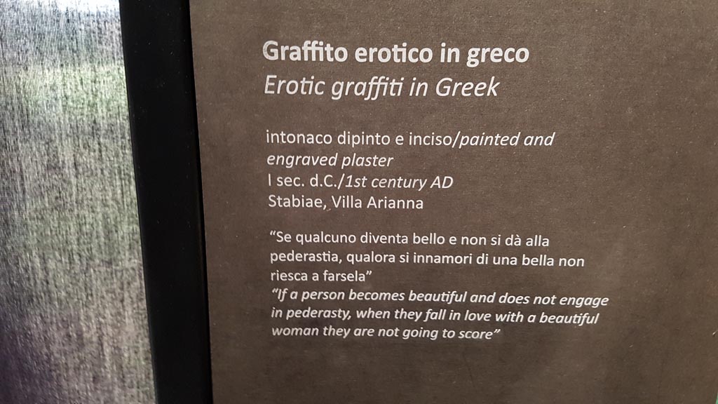 Stabiae, Villa Arianna. August 2023. 
Room 21, description card for erotic graffito cut from west wall. Photo courtesy of Maribel Velasco.