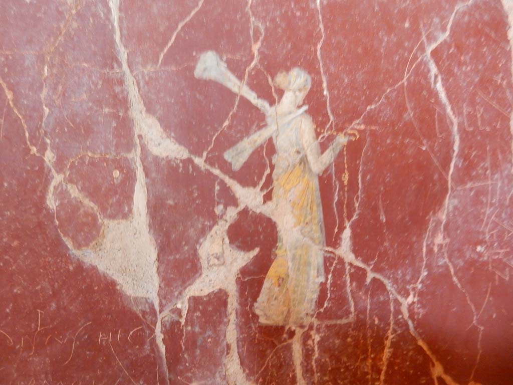 Stabiae, Villa Arianna, June 2019. W.28, painted figure in centre of panel with graffiti, on south wall.
Photo courtesy of Buzz Ferebee.