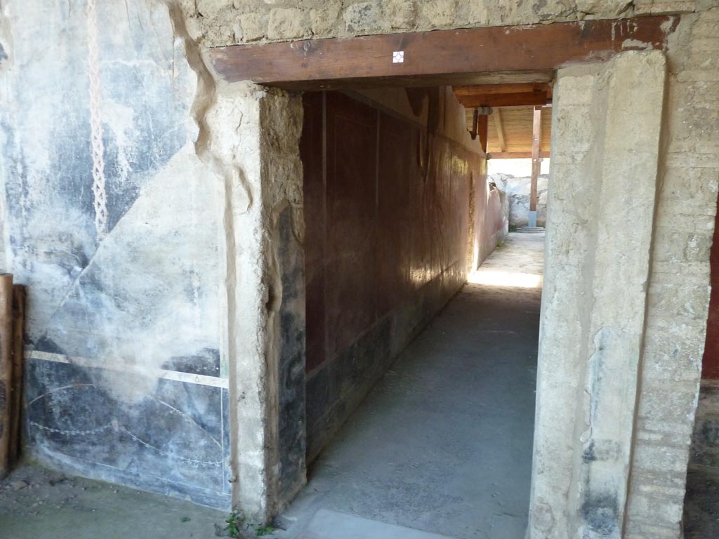 Stabiae, Villa Arianna, September 2015. 
W.22, west portico of peristyle, looking west towards remains of painted decoration on south side of doorway to corridor W.27.
