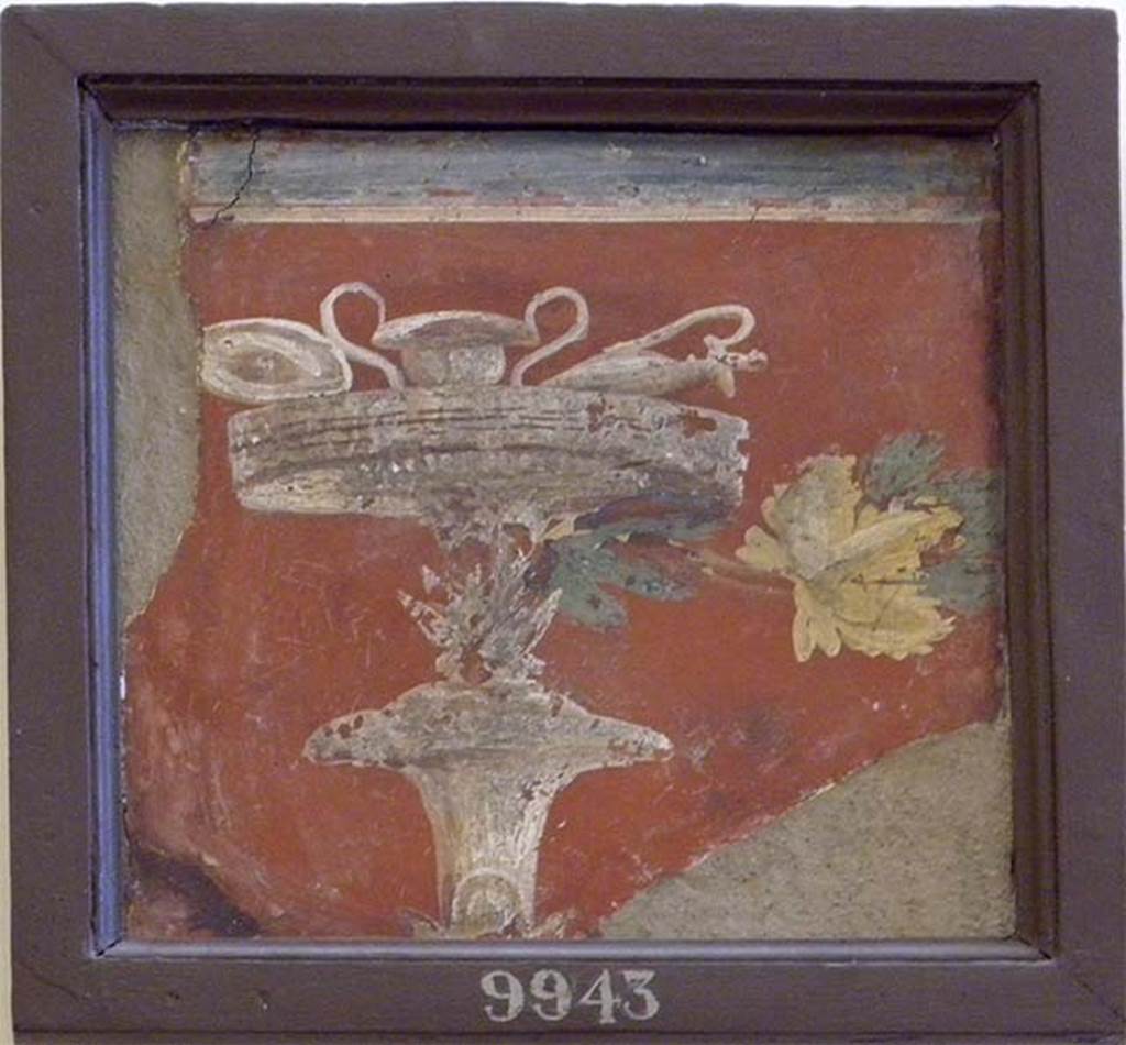 Stabiae, Villa Arianna, found September 1761. Atrium, wall painting of a candelabra topped with a cista (sacred utensil container).
The cista, used primarily in Dionysian rites, contains a rhyton and kantharos, with the sacred vine leaf to the right, all symbols of the god.
Now in Naples Archaeological Museum. Inventory number 9943. 
See Sampaolo V. and Bragantini I., Eds, 2009. La Pittura Pompeiana. Electa: Verona, p. 448.
