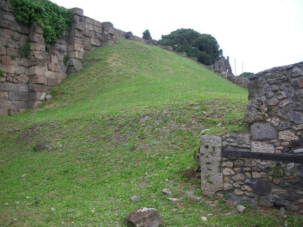 City Wall on east side of Tower XI, on north side of Pompeii. May 2010. 
Looking east towards Tower X, centre right, with VI.9.1, on right. Photo courtesy of Ivo van der Graaff.