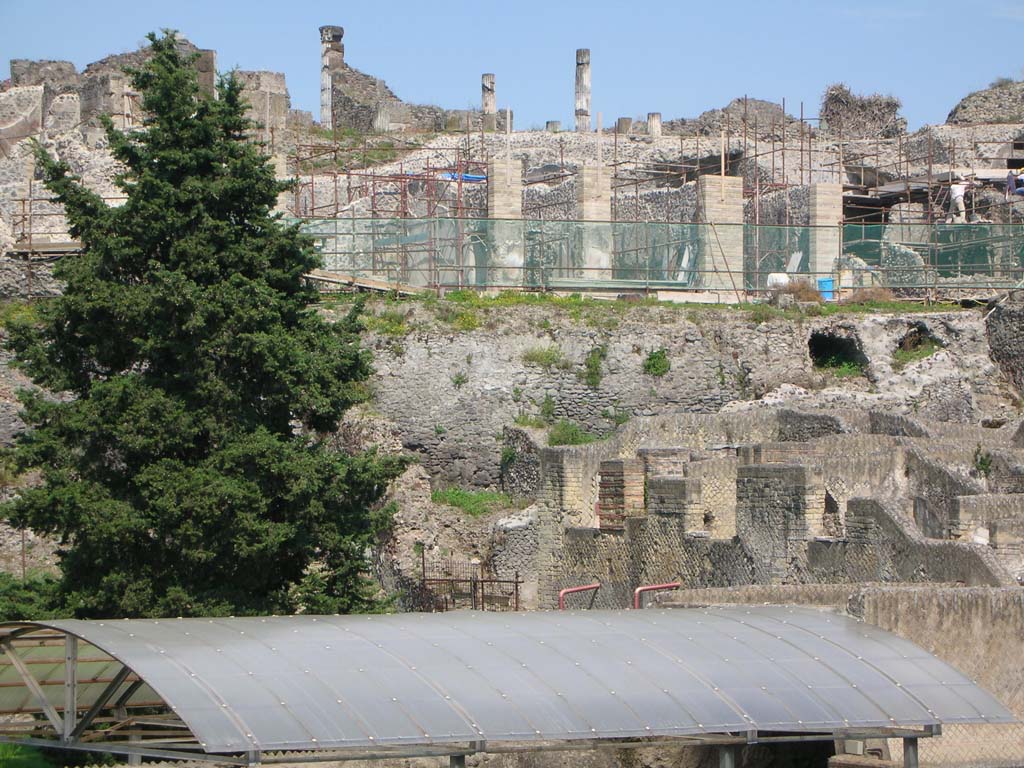 Walls on west side of Pompeii. May 2010. 
Looking east to City Walls, below VII.16.15, and above roof of Suburban Baths. Photo courtesy of Ivo van der Graaff.